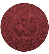 Round burgundy hand-tufted wool rug with embossed floral design